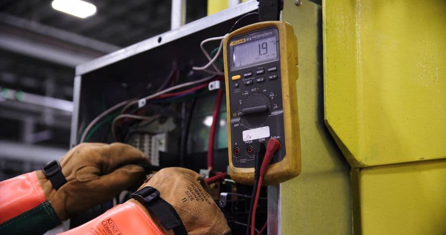 Technician working on an electrical control panel